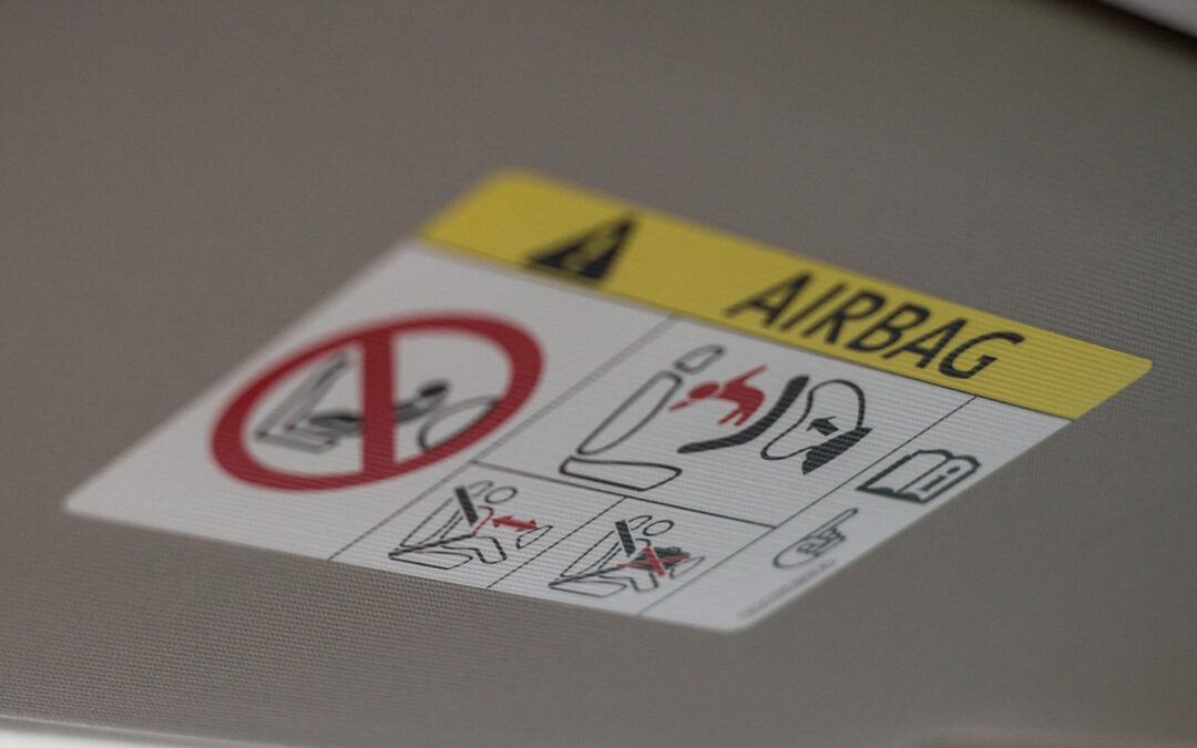 photo of a warning label depicting one of the car safety features