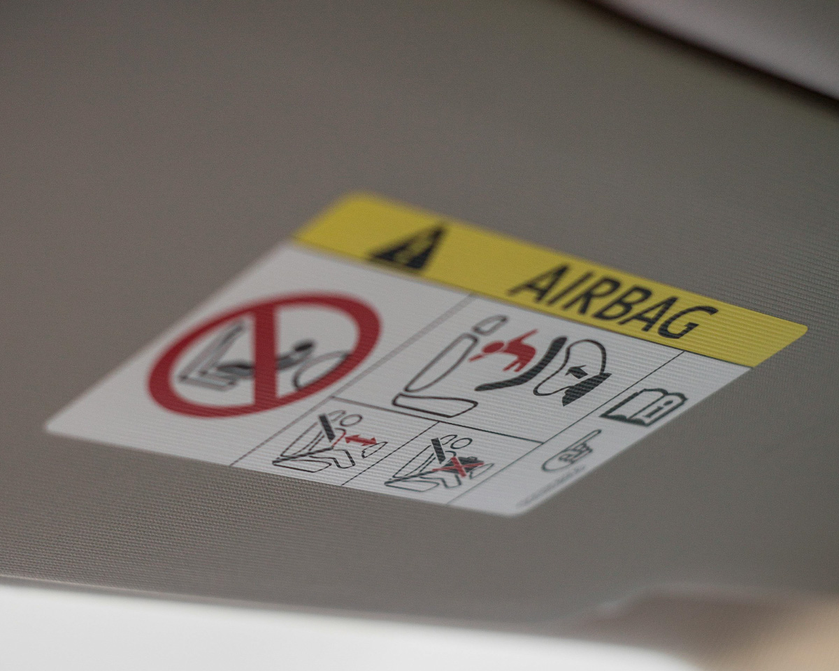photo of a warning label depicting one of the car safety features