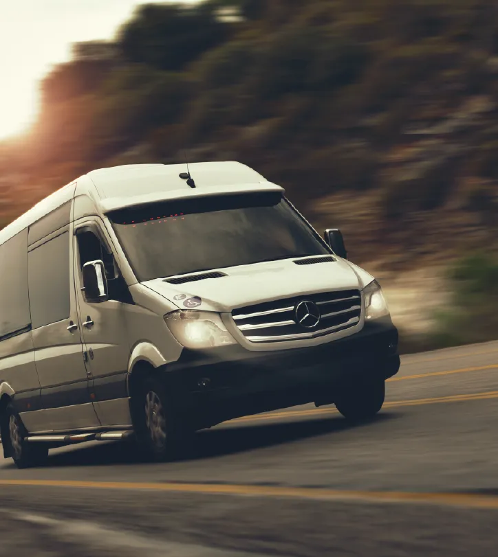 sprinter van on the road photo of a sprinter van speeding through the rain with motion blur